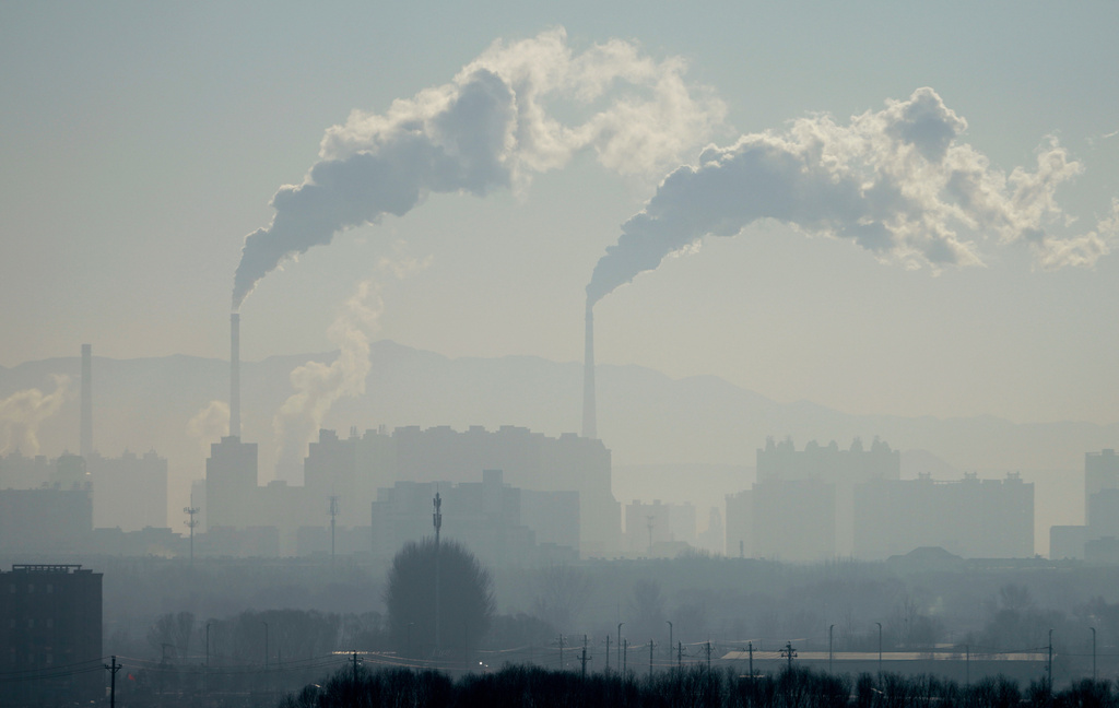 CORRECTS THE LOCATION OF THE AREA TO NORTHEASTERN, NOT NORTHWESTERN - A power plant is seen in China's northeastern region, as seen from a train from Beijing to Shenyang on Jan. 3, 2026. (AP Photo/Ng Han Guan)