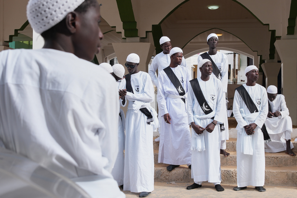 The Layene Brotherhood waits outside a mosque ahead of the Eid al-Fitr prayers, marking the end of the holy fasting month of Ramadan in Dakar, Senegal, Saturday, March 21, 2026. (AP Photo/Misper Apawu)