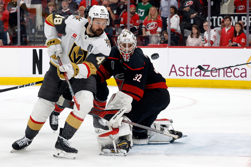 Carolina Hurricanes goaltender Brandon Bussi (32) watches the puck with Vegas Golden Knights' Tomas Hertl (48) during the third period in Game 5 of the NHL hockey Stanley Cup Final series in Raleigh, N.C., Thursday, June 11, 2026. (AP Photo/Karl DeBlaker)