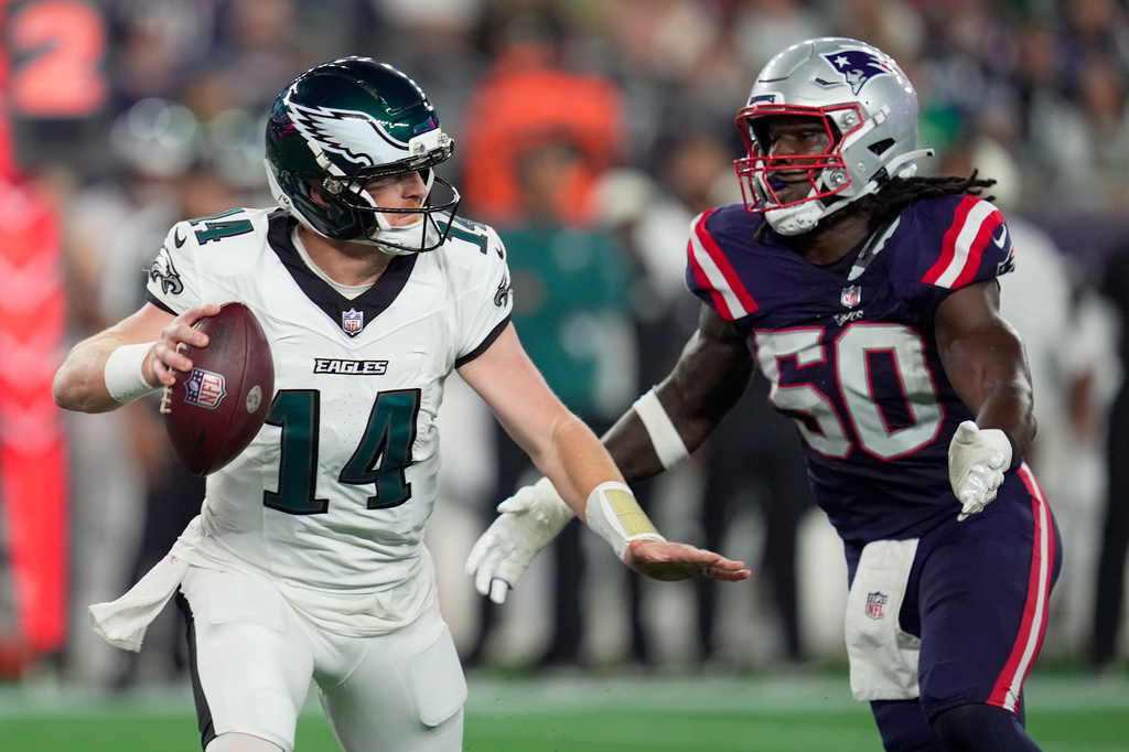 Philadelphia Eagles quarterback Andy Dalton (14) is pressured by New England Patriots linebacker Gabe Jacus during the first half of an NFL preseason football game, Saturday, Aug. 22, 2026, in Foxborough, Mass. (AP Photo/Robert F. Bukaty)