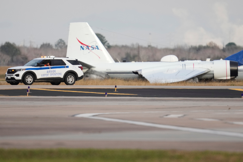 A NASA aircraft sits near a runway at Ellington Airport after making a belly landing on Tuesday, Jan. 27, 2026, in Houston. (AP Photo/Ashley Landis)