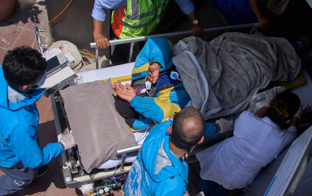 Medics take Dawa Sherpa, a mountain guide who had been missing for several days in the Everest region, for treatment after he arrived at Grande Hospital in Kathmandu, Nepal, Thursday, June 4, 2026. (AP Photo/Niranjan Shrestha)