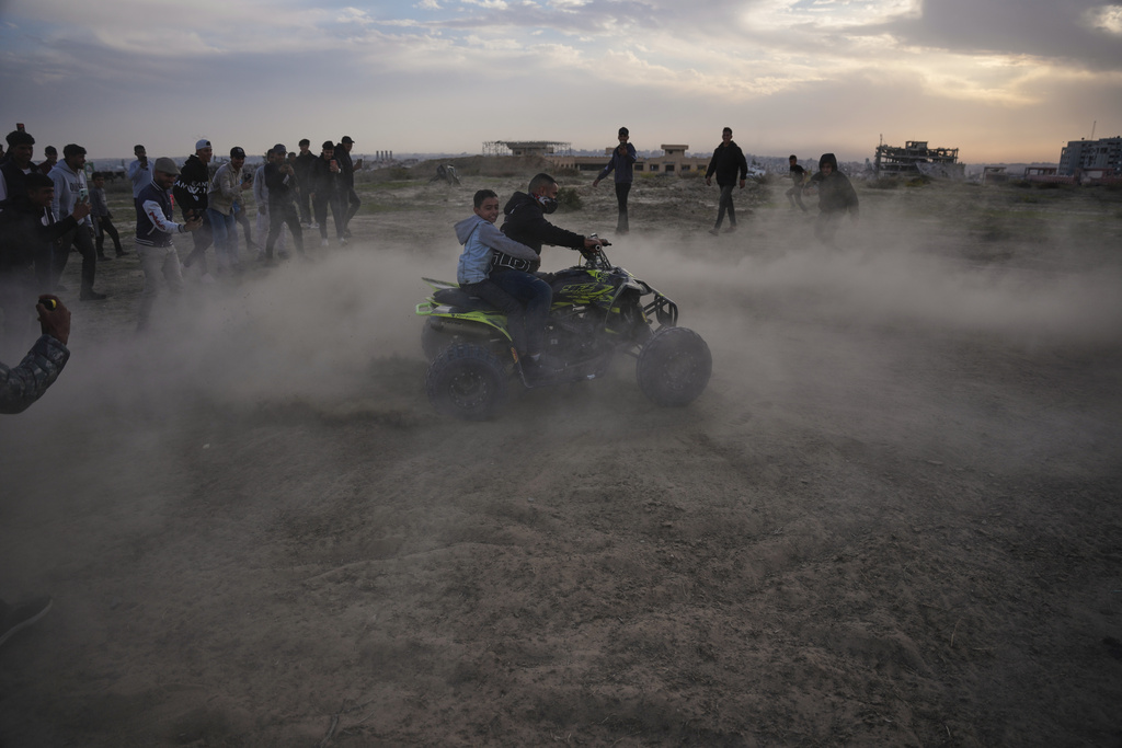 A young Palestinian man rides an ATV on a sand dune in the Al-Zahra area, in the central Gaza Strip, Friday, Dec. 5, 2025.(AP Photo/Abdel Kareem Hana)
