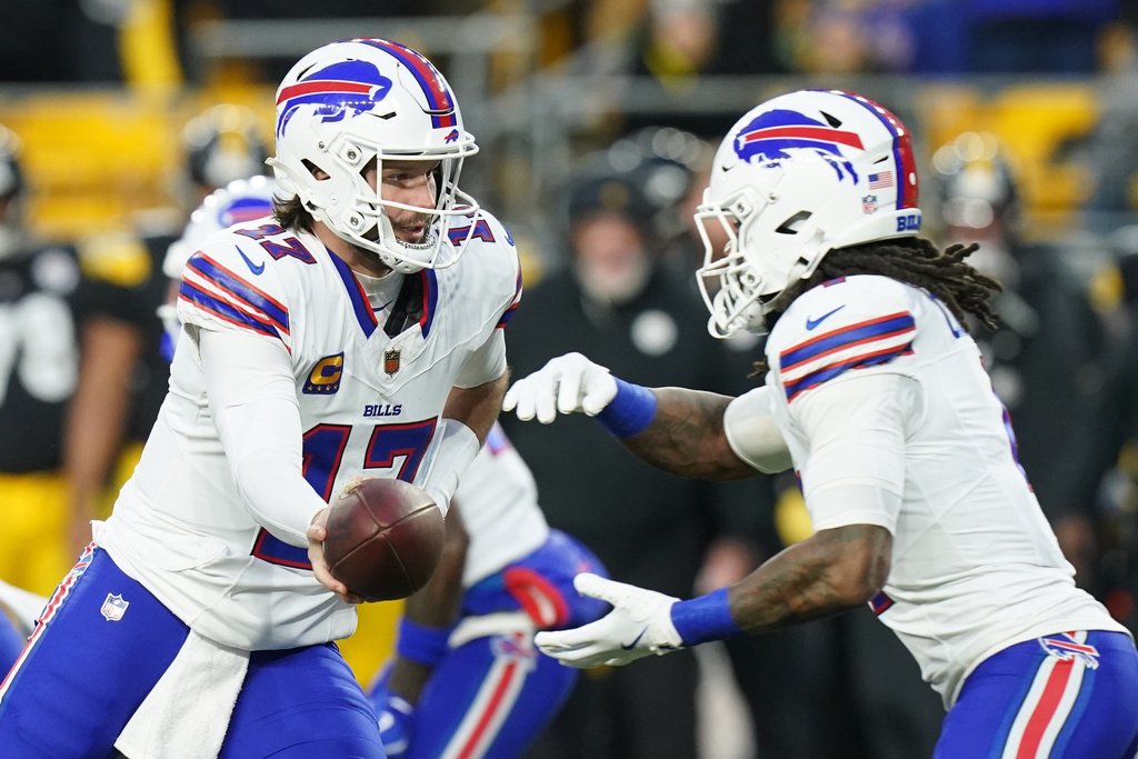 Buffalo Bills quarterback Josh Allen (17) hands off to running back James Cook III (4) during the first half of an NFL football game against the Pittsburgh Steelers Sunday, Nov. 30, 2025, in Pittsburgh. (AP Photo/Matt Freed)