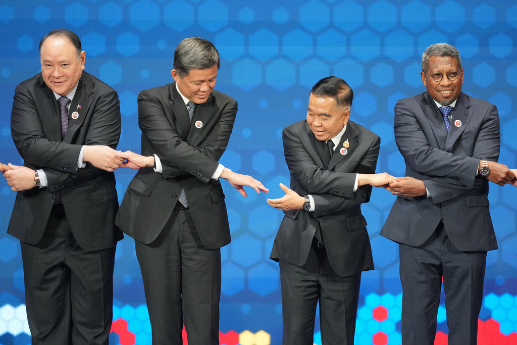 From left, Philippine's Defense Secretary Gilberto Teodoro, Singapore's Defense Minister Chan Chun Sing, Thailand's Defense Minister Natthaphon Narkphanit and East Timor's Defense Minister Donaciano da Costa Gomes hold hands as they pose for a group photo during the opening session of the Association of Southeast Asian Nations (ASEAN) Defense Ministers' Meeting in Kuala Lumpur, Malaysia, Friday, Oct. 31, 2025. (AP Photo/Dita Alangkara, Pool)
