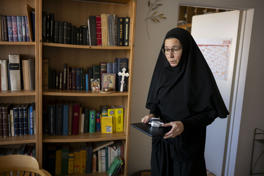 Sister Vassa Larin, a prominent American Orthodox nun, public speaker and YouTube presenter, prepares in her room for recording one of her videos in Vienna, Austria, on Wednesday, Sept 3. 2025. (AP Photo/Denes Erdos)