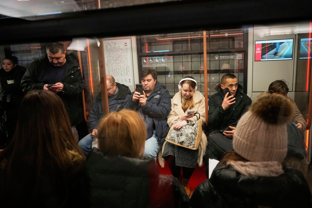 FILE - Passengers look at their smartphones while on the subway in Moscow, Russia, March 4, 2025. (AP Photo/Alexander Zemlianichenko, File)