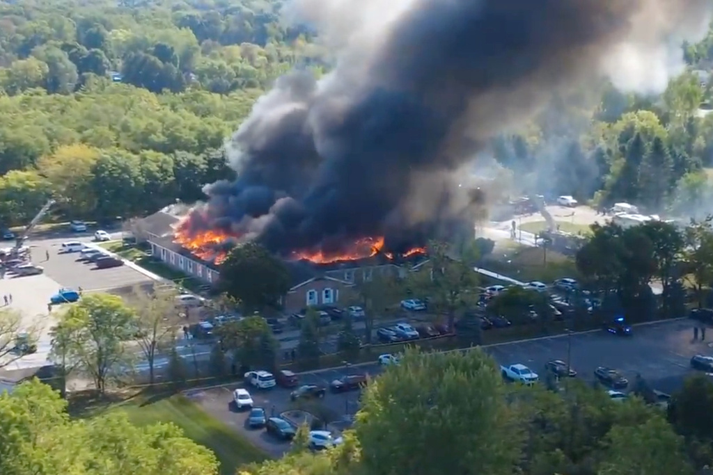 In this image taken from video released by Julie J, @Malkowski6April, Massive flames and smoke rise from The Church of Jesus Christ of Latter-day Saints in Grand Blanc, about 50 miles north of Detroit, Sunday, Sept. 28, 2025. (Julie J, @Malkowski6April via AP)