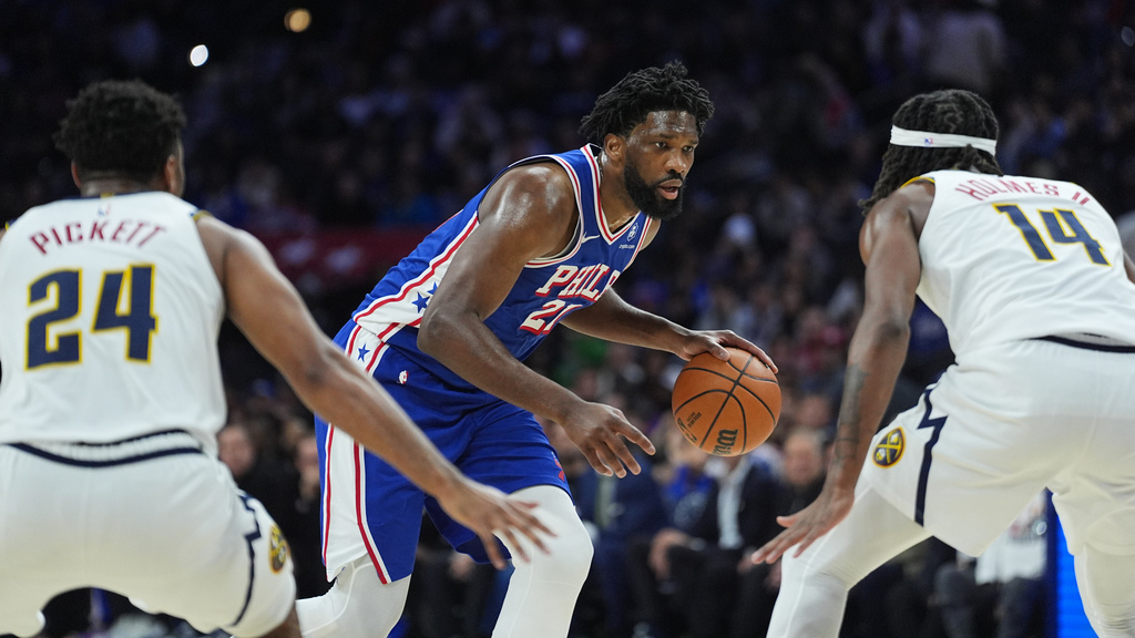 Philadelphia 76ers' Joel Embiid tries to get a shot past Denver Nuggets' Jalen Pickett (24) and Daron Holmes II during the first half of an NBA basketball game Monday, Jan. 5, 2026, in Philadelphia. (AP Photo/Matt Rourke)