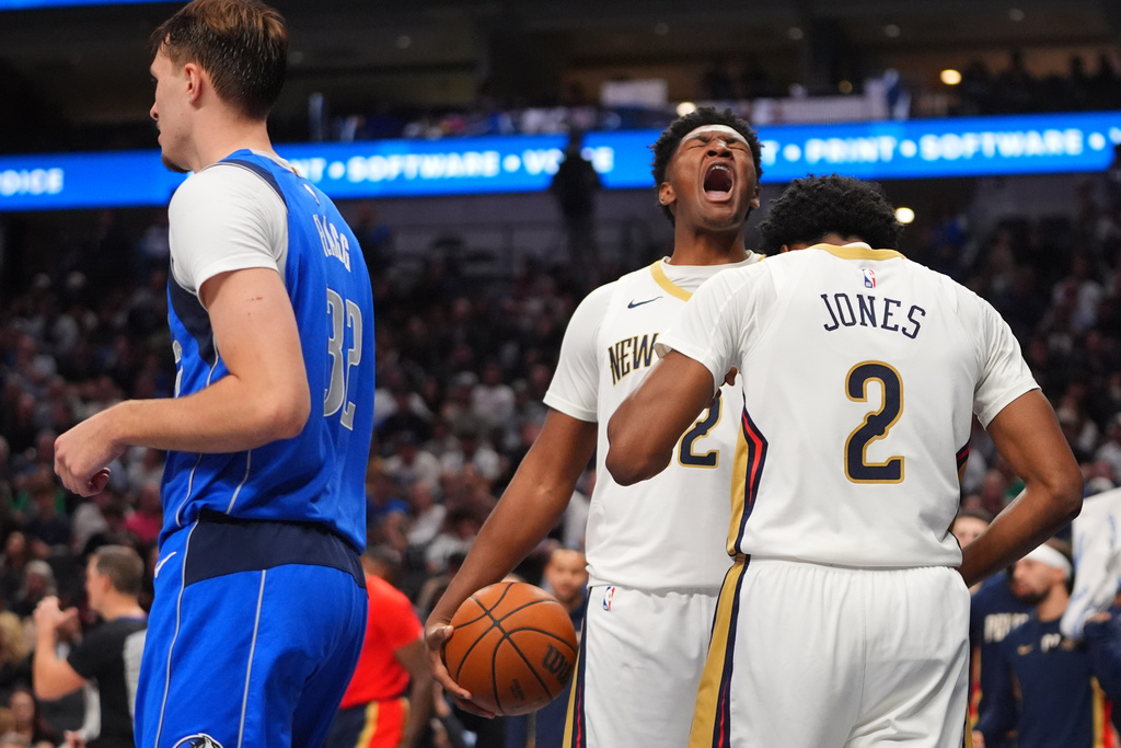 New Orleans Pelicans center Derik Queen, center, yells with teammate forward Herbert Jones (2) as Dallas Mavericks forward Cooper Flagg (32) walks away during the second half of an NBA basketball game in Dallas, Wednesday, Nov. 5, 2025. (AP Photo/LM Otero)