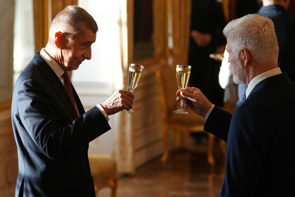 Leader of ANO political movement Andrej Babis, left, toasts with Czech Republic's President Petr Pavel after being sworn in as the country's new prime minister at the Prague Castle in Prague, Czech Republic, Tuesday, Dec. 9, 2025. (AP Photo/Petr David Josek)