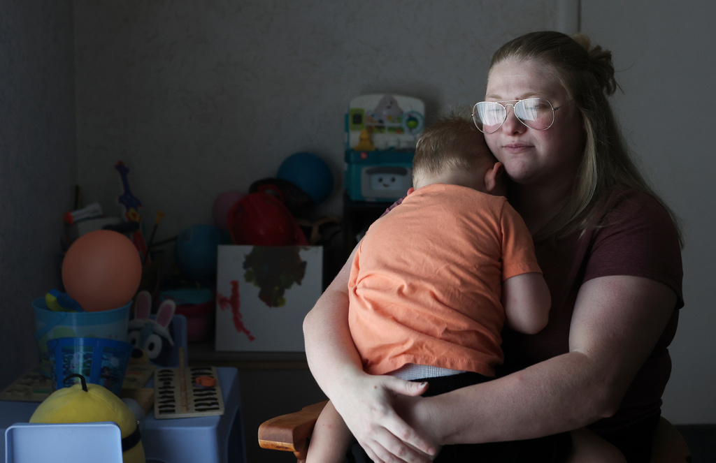 Meygan Maloney poses for a portrait with her son Callum Wilson, 3, Friday, Aug. 28, 2026, at their home in Hartford City, Ind. (AP Photo/Cara Penquite)
