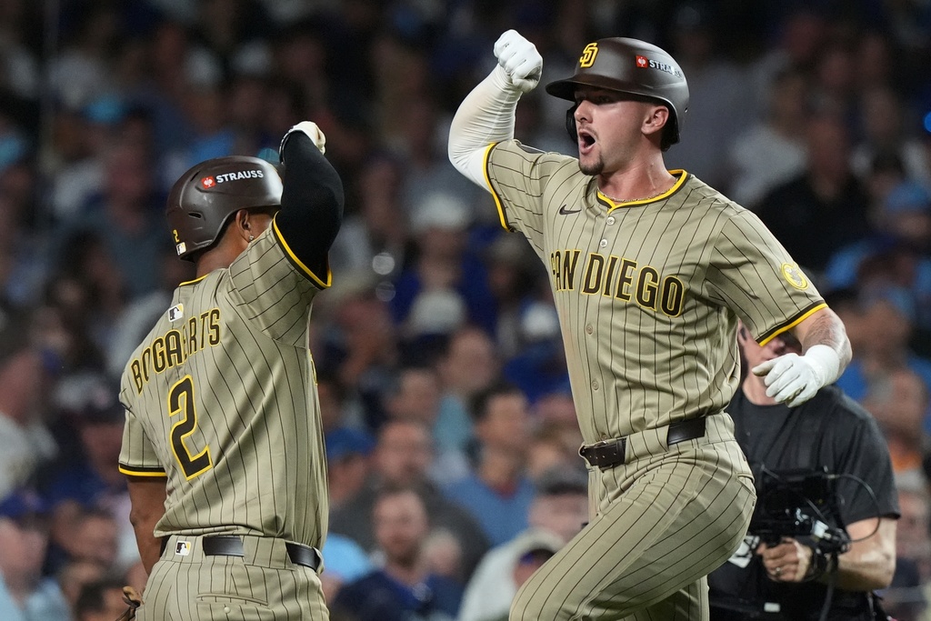 San Diego Padres' Jackson Merrill celebrates his home run with Xander Bogaerts during the ninth inning of Game 3 of a National League wild card baseball game against the Chicago Cubs Thursday, Oct. 2, 2025, in Chicago. (AP Photo/Nam Huh)