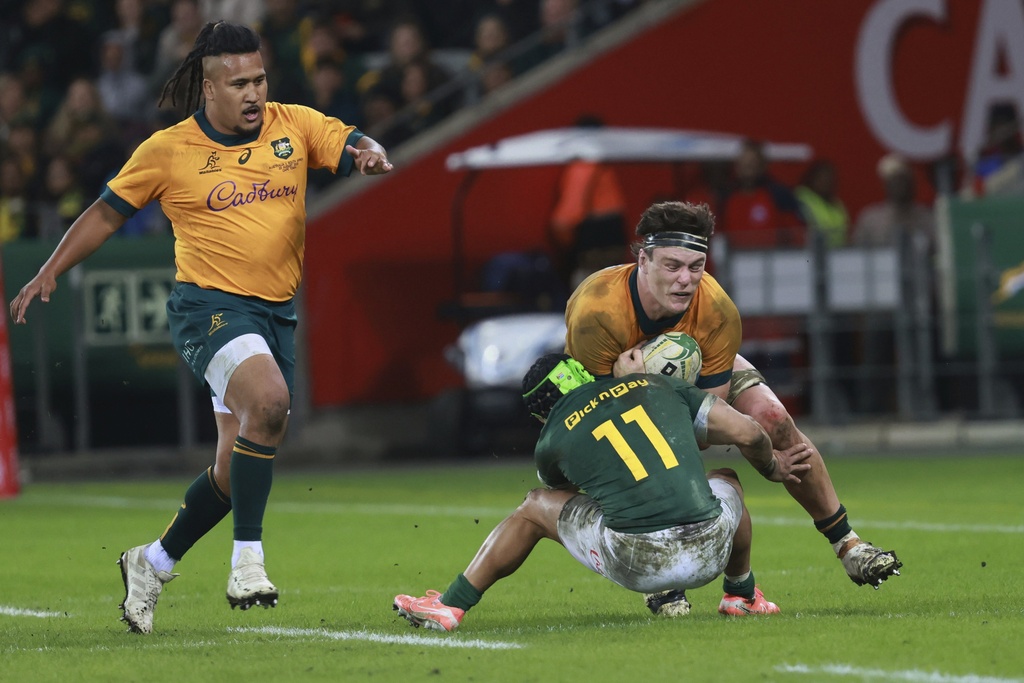 Australia's Tom Hooper, right, is tackled by South Africa's Cheslin Kolbe during a rugby championship test match between South Africa and Australia, at Cape Town stadium in Cape Town, South Africa, Saturday, Aug. 23, 2025. (AP Photo/Halden Krog)