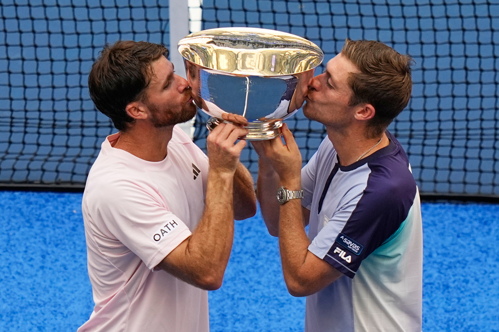 Christian Harrison, of the United States, left, and Neal Skupski, of Britain, right, pose for a photo with their trophy after winning the men's doubles final of the U.S. Open tennis championships against Kevin Krawietz, of Germany, and Tim Puetz, of Germany, Saturday, Sept. 12, 2026, in New York. (AP Photo/Frank Franklin II)