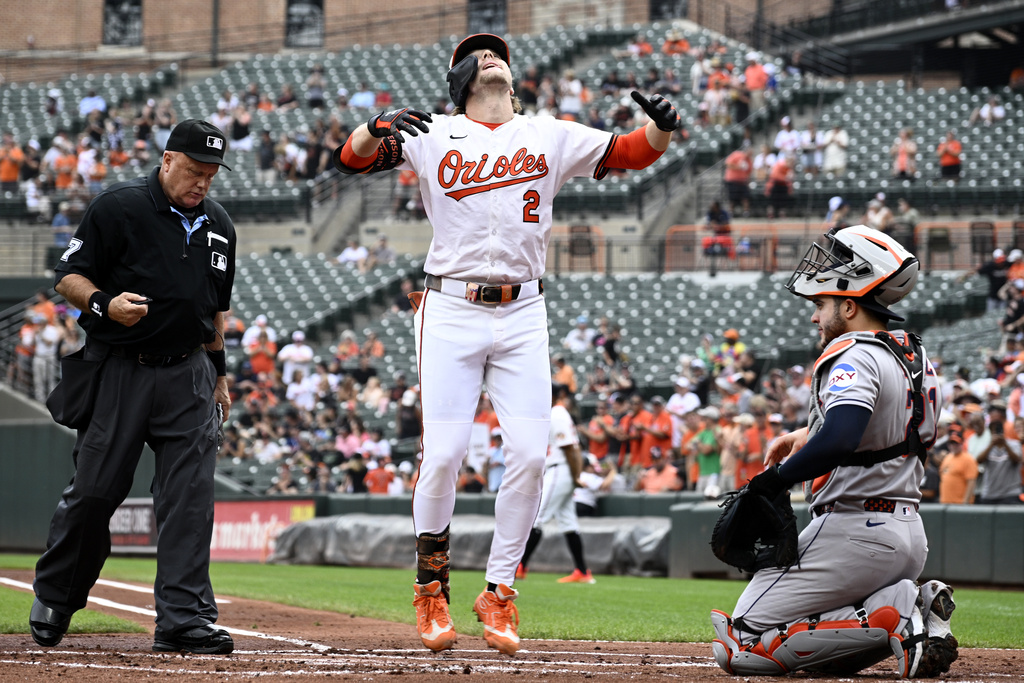 Baltimore Orioles' Gunnar Henderson (2) celebrates his home run in front of Houston Astros catcher Yainer Diaz, right, during the first inning of a baseball game, Sunday, Aug. 24, 2025, in Baltimore. (AP Photo/Nick Wass)