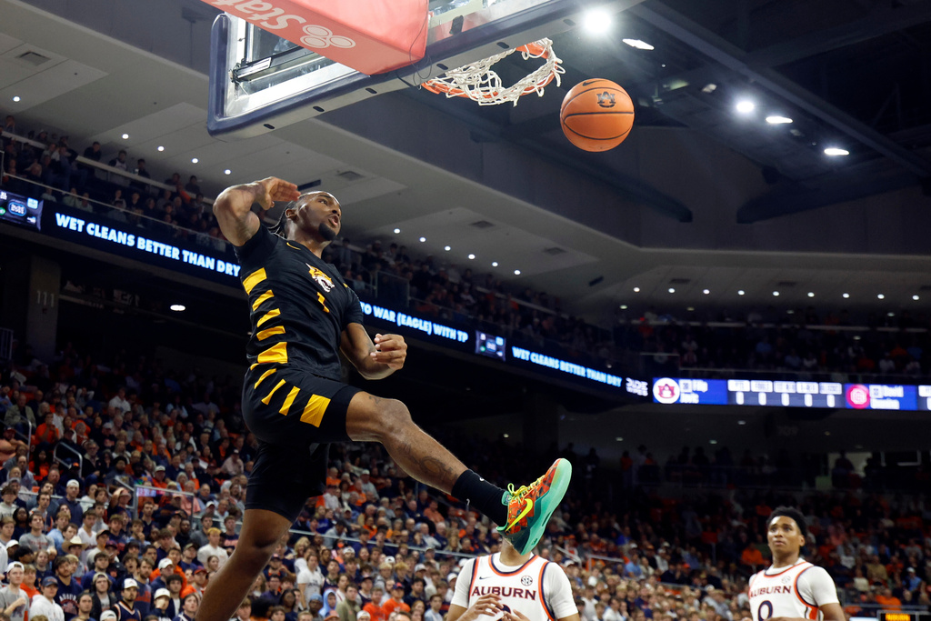 Bethune-Cookman guard Arterio Morris (1) slam dunks the ball during the first half of an NCAA college basketball game against Auburn, Monday, Nov. 3, 2025, in Auburn, Ala. (AP Photo/Butch Dill)