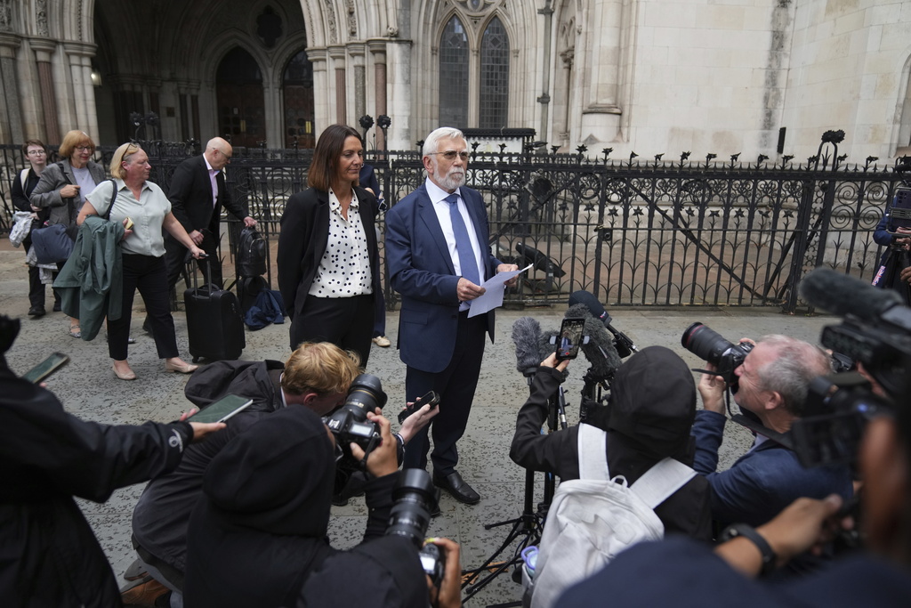Ken Williamson, Councillor of Epping Forest District Council, front, speaks to press after the judgment due in Home Office and hotel owner's appeal bids against Epping asylum seeker ruling, at The Royal Courts Of Justice in London, Friday, Aug. 29, 2025. (AP Photo/ Joanna Chan)