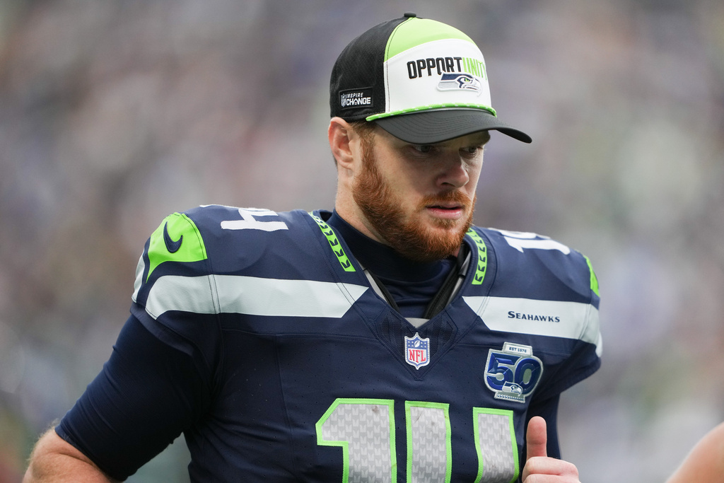 Seattle Seahawks quarterback Sam Darnold (14) runs off the field for half time in an NFL football game against the Indianapolis Colts, Sunday, Dec. 14, 2025, in Seattle. (AP Photo/Lindsey Wasson)