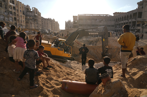 Palestinians watch machinery and some workers from Egypt searching for the bodies of hostages at Hamad City, in Khan Younis, southern Gaza Strip, Sunday, Oct. 26, 2025. (AP Photo/Jehad Alshrafi) Palestinians watch machinery and some workers from Egypt searching for the bodies of hostages at Hamad City, in Khan Younis, southern Gaza Strip, Sunday, Oct. 26, 2025. (AP Photo/Jehad Alshrafi)