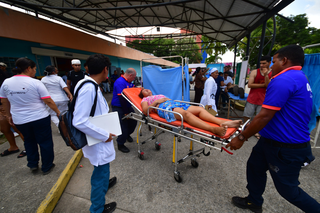 Paramedics carry an injured person at a hospital in Moron,near the epicenter of two earthquakes that struck Venezuela a day earlier, Thursday, June 25, 2026. (AP Photo/Jacinto Oliveros)