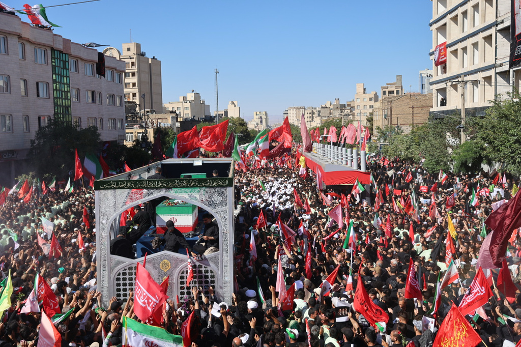 A truck carrying the coffins of the late Iranian Supreme Leader Ayatollah Ali Khamenei and members of his family moves through a main avenue lined with thousands of mourners during the final stage of funeral ceremonies in Mashhad, northeastern Iran, Thursday, July 9, 2026. (Mohammad Hasan Salavati/Shahraranews via AP)