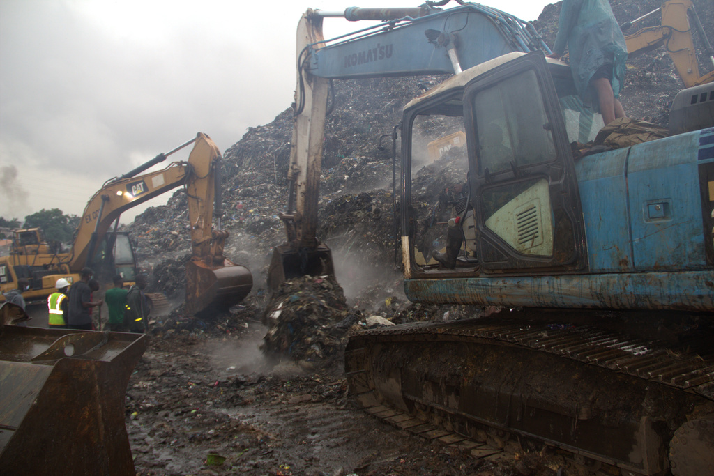 Rescue workers search through a heap of refuse after it collapsed at Conakry’s largest landfill, Guinea, Sunday, Aug. 23, 2026. (AP Photo/Fodo Toure)