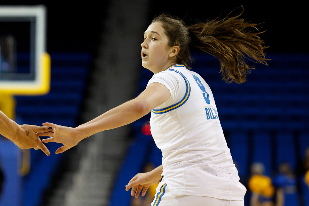 UCLA guard Lena Bilic (9) is greeted by center Lauren Betts, left, after scoring during the first half of an NCAA college basketball game Sunday, Dec. 7, 2025, in Los Angeles. (AP Photo/Caroline Brehman)