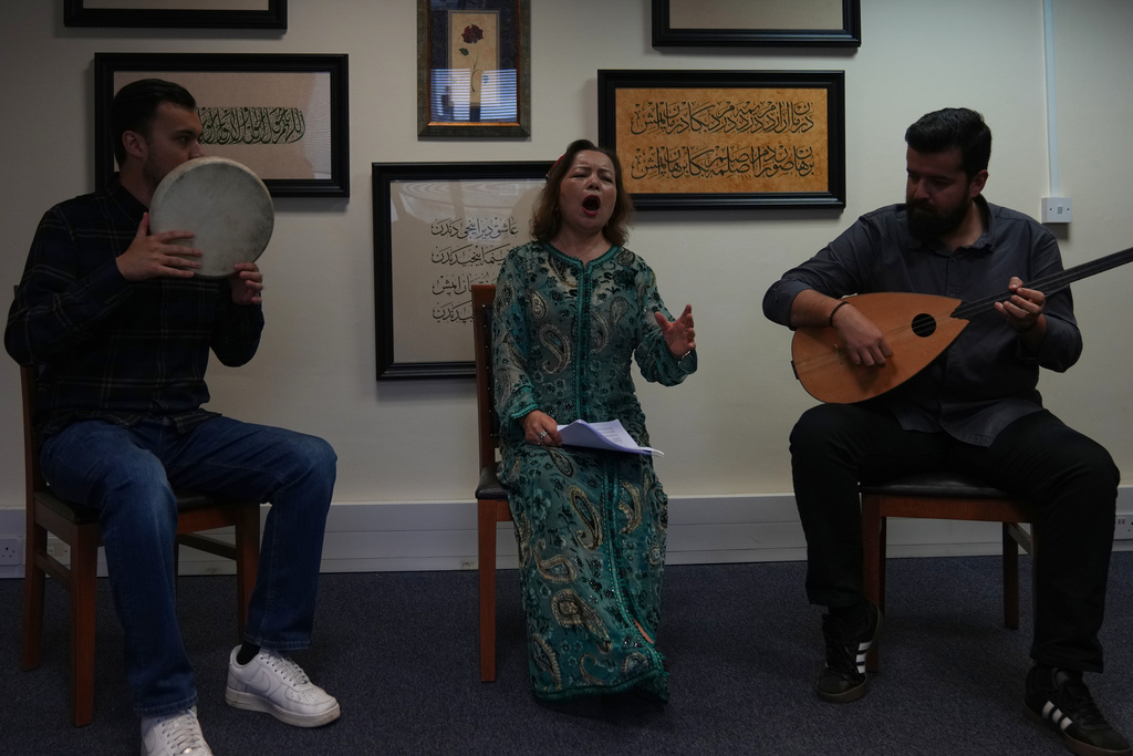 Members of the London Uyghur Ensemble perform during an interview with The Associated Press in London, Wednesday, Oct. 8, 2025. (AP Photo/Joanna Chan)