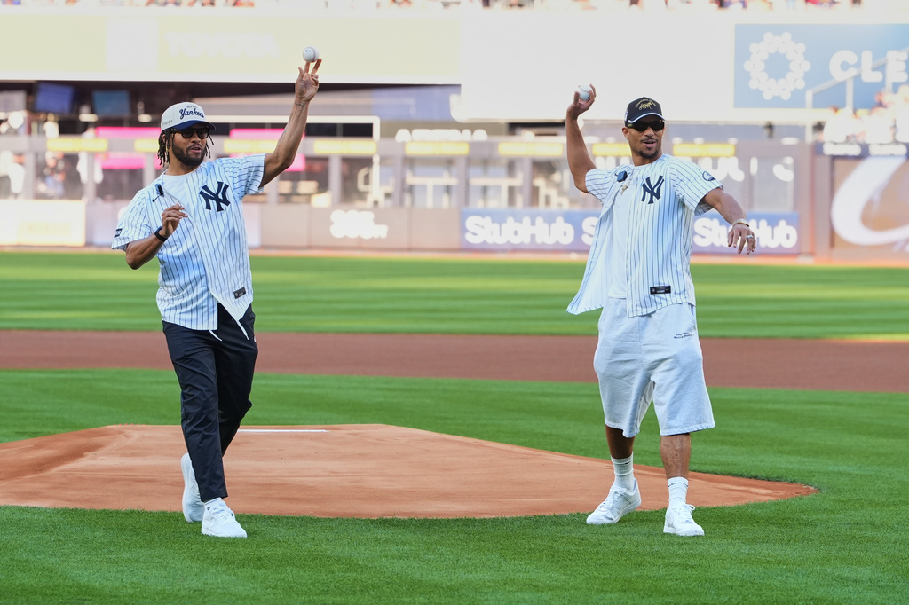 New York Knicks' Josh Hart, right, and Jalen Brunson throw out a ceremonial first pitch before a baseball game between the Chicago White Sox and the New York Yankees Wednesday, June 17, 2026, in New York. (AP Photo/Frank Franklin II)