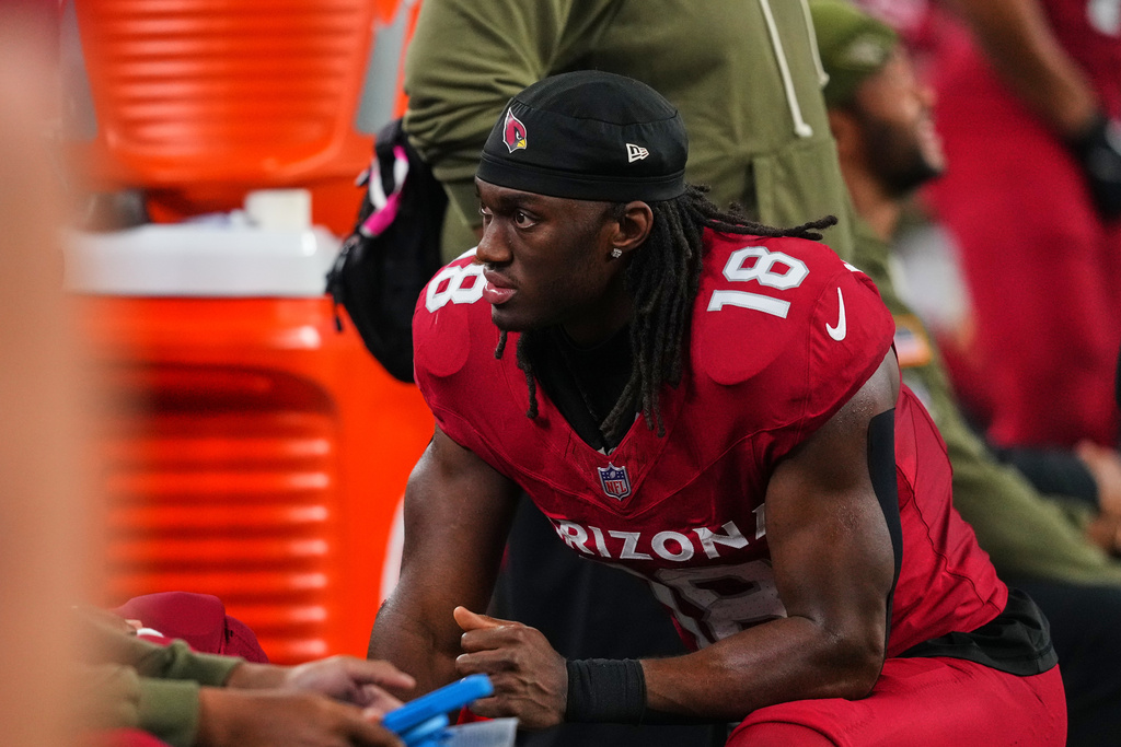 Arizona Cardinals wide receiver Marvin Harrison Jr. (18) talks with teammates on the sideline in the second half of an NFL football game against the Dallas Cowboys Monday, Nov. 3, 2025, in Arlington, Texas. (AP Photo/Julio Cortez)