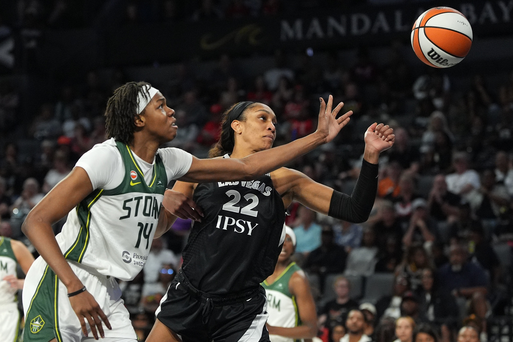 Seattle Storm center Dominique Malonga (14) and Las Vegas Aces center A'ja Wilson (22) battle for the ball during the second half of a WNBA basketball game Sunday, Sept. 20, 2026, in Las Vegas. (AP Photo/John Locher)