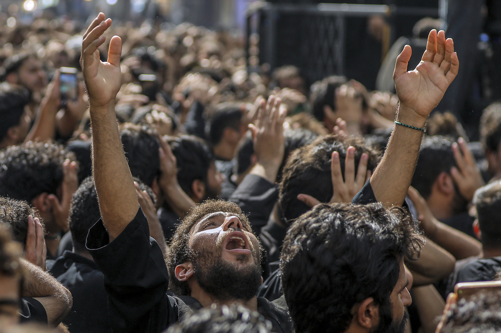 Shiite pilgrims participate in Arbaeen, which marks the end of the 40-day mourning period following Ashoura, in Karbala, Iraq, Thursday, Aug. 14, 2025. (AP Photo/Ammar Khalil)