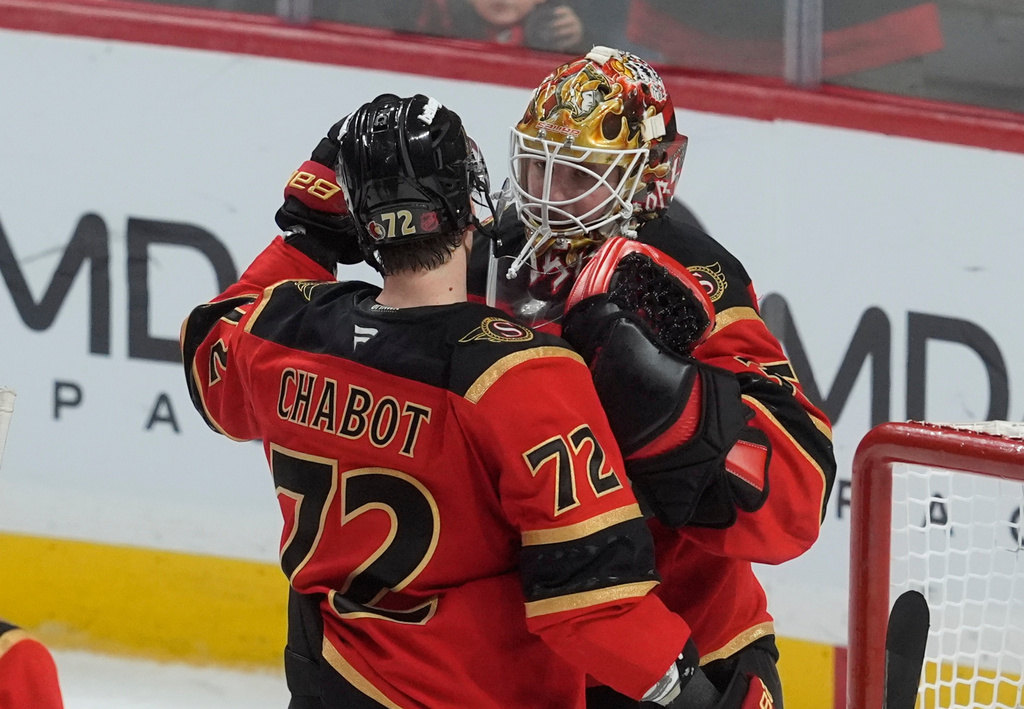 Ottawa Senators' Thomas Chabot (72) is congratulated by goaltender Linus Ullmark (35) after defeating the Florida Panthers in NHL action in Ottawa, Ontario, Thursday, April 9, 2026. (Adrian Wyld/The Canadian Press via AP)