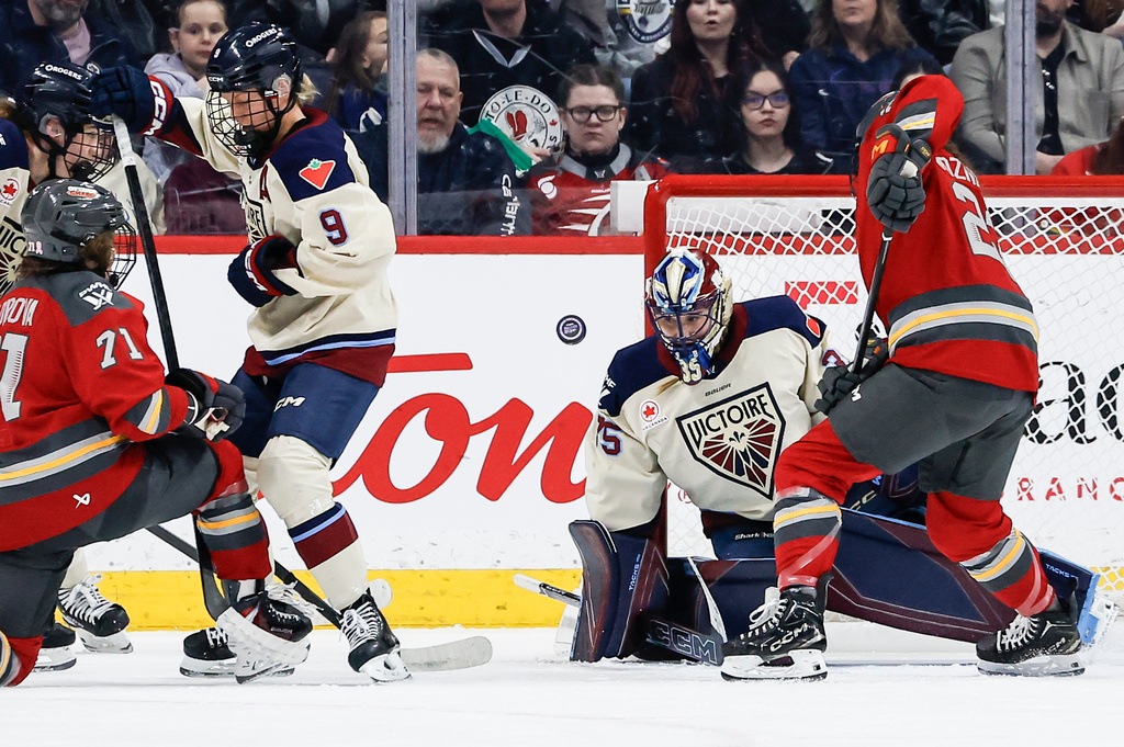 Ottawa Charge's Sarah Wozniewicz (23) looks for the rebound as Montreal Victoire goaltender Ann-Renee Desbiens (35) saves the shot during first period PWHL hockey game action in Winnipeg, Canada, Sunday, March 22, 2026. (John Woods/The Canadian Press via AP)
