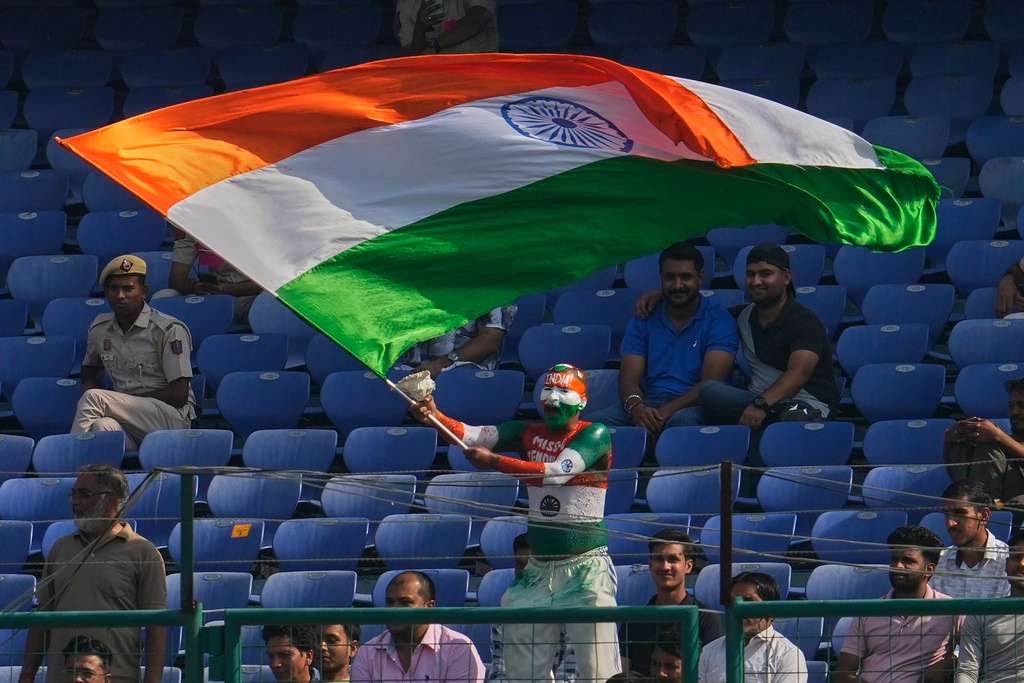 An cricket fan painted in colors of Indian flag waves national flag on the fifth day of the second cricket test match between India and West Indies at the Arun Jaitley Stadium in New Delhi, India, Tuesday, Oct.14, 2025. (AP Photo/Manish Swarup)