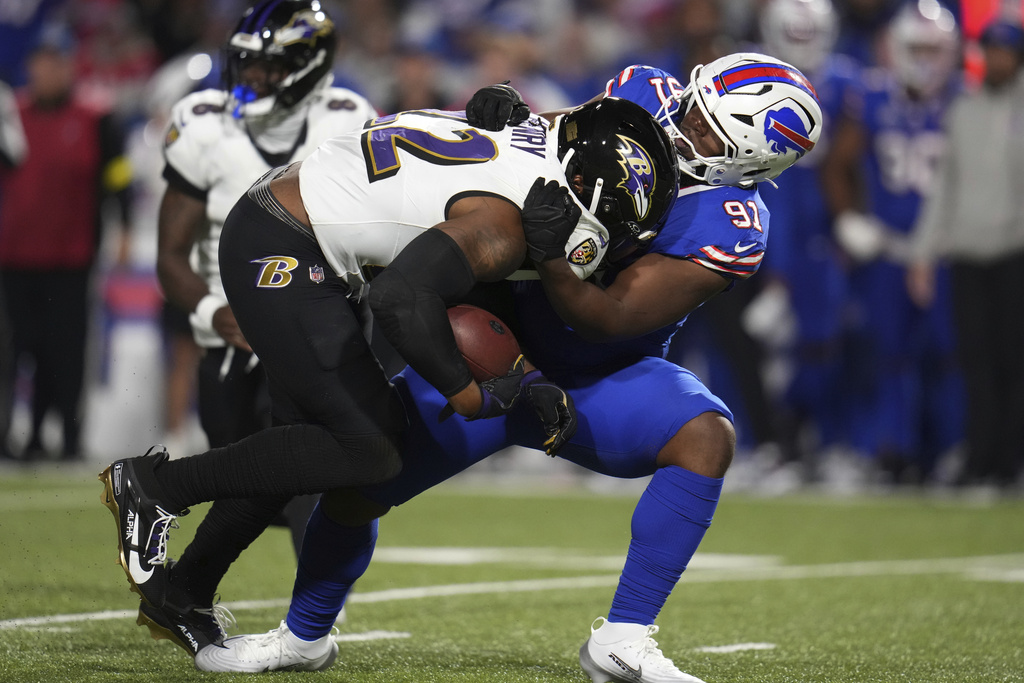 Baltimore Ravens running back Derrick Henry (22) is stopped by Buffalo Bills defensive tackle Ed Oliver (91) during the second half of an NFL football game in Orchard Park, N.Y., Sunday, Sept. 7, 2025. (AP Photo/Gene J. Puskar)