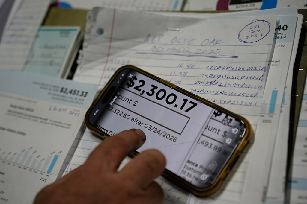 Eric Pinson, manager and resident of the Lock 24 RV Park and Campground, one of two such locations he manages in the area, looks over the business' electric bills, at his home at the campground in Racine, Ohio, Friday, March 13, 2026. (AP Photo/Carolyn Kaster)