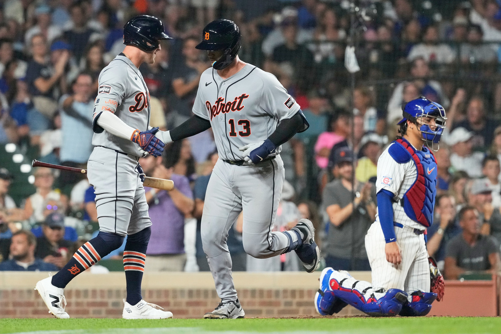 Detroit Tigers' Dillon Dingler (13) celebrates with Kerry Carpenter, left, after hitting a solo home run during the eighth inning of a baseball game against the Chicago Cubs in Chicago, Monday, July 20, 2026. (AP Photo/Nam Y. Huh)