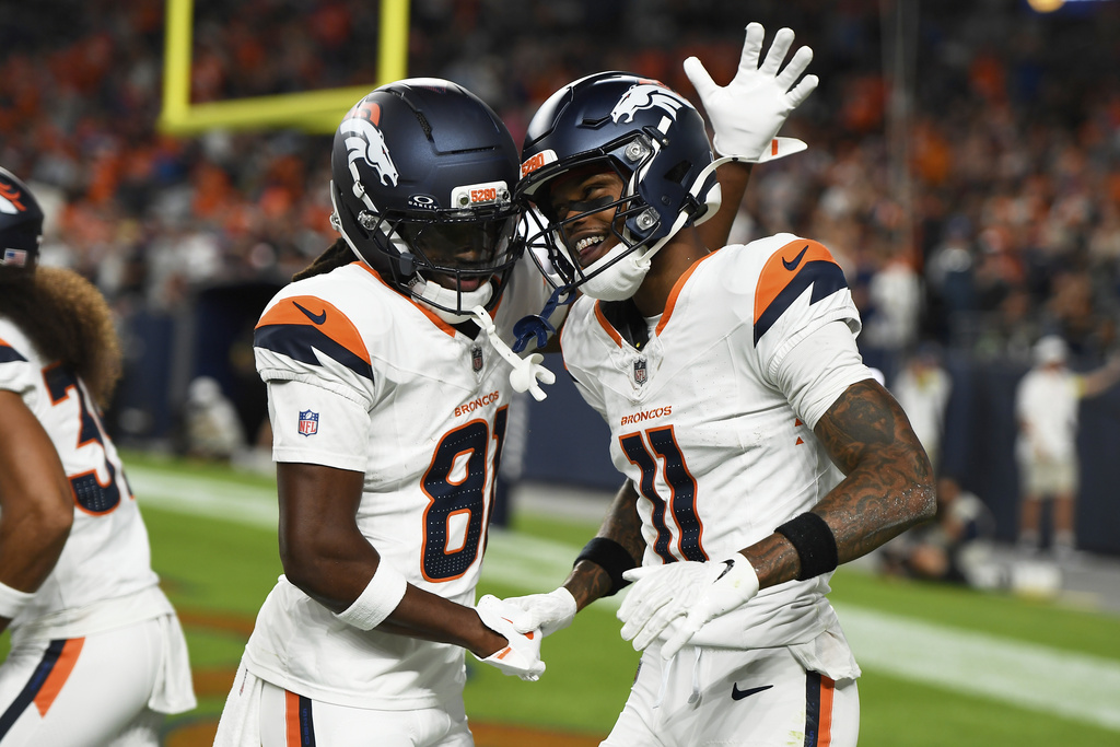 Denver Broncos wide receiver Troy Franklin (11) celebrates with teammate Jerjuan Newton (81) after a touchdown catch against the Arizona Cardinals during the first half of a preseason NFL football game Saturday, Aug. 16, 2025, in Denver. (AP Photo/Eric Lutzens)