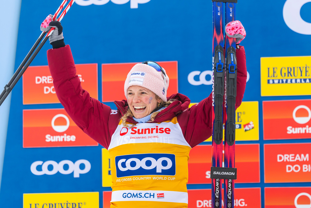 Second placed Jessie Diggins of United States celebrates on the podium after the women's 20km mass start classic skiing race, at the FIS Cross-Country World Cup at the Nordic Center Goms, in Geschinen, Switzerland, Sunday, Jan. 25, 2026. (Salvatore Di Nolfi/Keystone via AP)