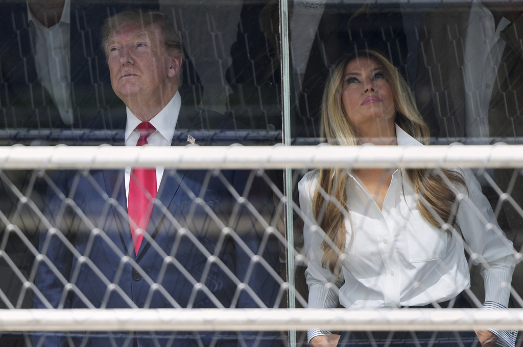 President Donald Trump, left, and first lady Melania Trump attend the IndyCar Freedom 250 Grand Prix auto race, Sunday, Aug. 23, 2026, in Washington. (AP Photo/Julia Demaree Nikhinson)