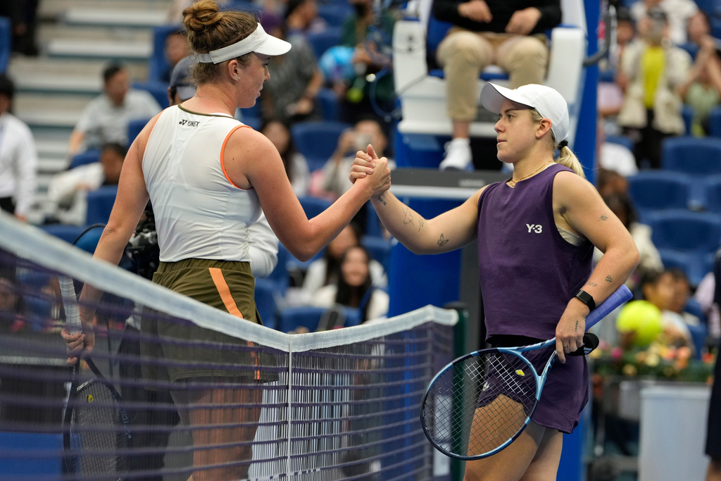 Linda Noskova of the Czech Republic, left shakes hands after defeating Sonay Kartal of Britain in a women's singles quarterfinal match of the China Open tennis tournament in Beijing, China, Friday, Oct. 3, 2025. (AP Photo/Ng Han Guan)