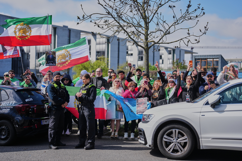 Supporters of Reza Pahlavi, exiled son of Shah Reza Pahlavi, shout slogans outside the building where Pahlavi holds a news conference in Berlin, Germany, Thursday, April 23, 2026. (AP Photo/Markus Schreiber)