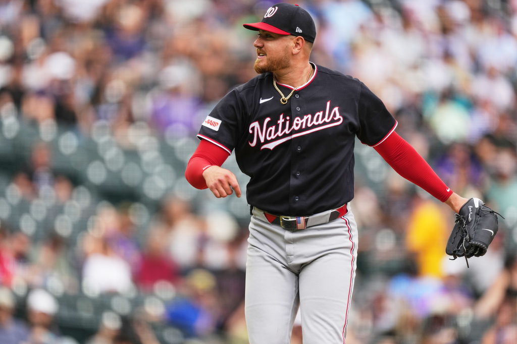 Washington Nationals starting pitcher Cade Cavalli reacts after striking out Colorado Rockies' Kyle Karros to end the sixth inning of a baseball game, Wednesday, July 22, 2026, in Denver. (AP Photo/David Zalubowski)