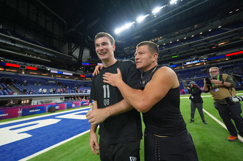 FILE - Vanderbilt quarterback Diego Pavia, right, celebrates with Indiana quarterback Fernando Mendoza after running drills at the NFL football scouting combine in Indianapolis, Saturday, Feb. 28, 2026. (AP Photo/Julio Cortez, File)
