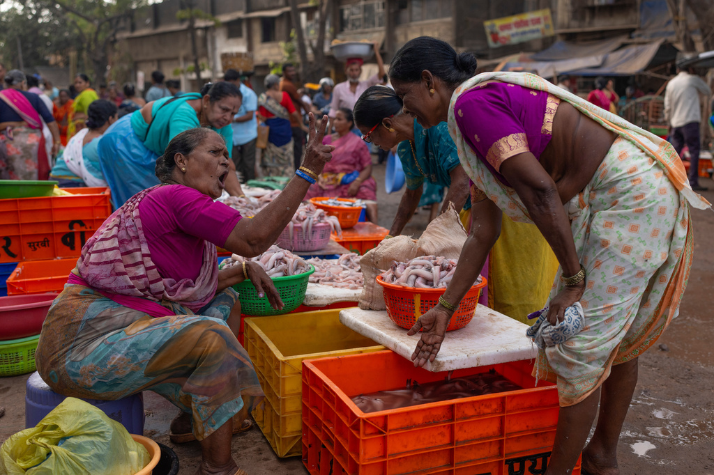 A fisherwoman haggles with a customer over price of fish at a fishmarket at Bhaucha Dhaka in Mumbai, India, Wednesday, April 8, 2026. (AP Photo/Rafiq Maqbool)