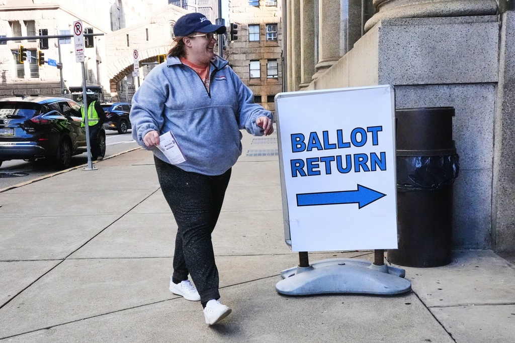 A voter drops off a mail-in ballot at the City-County Building in downtown Pittsburgh Tuesday, Nov. 4, 2025. (AP Photo/Gene J. Puskar)