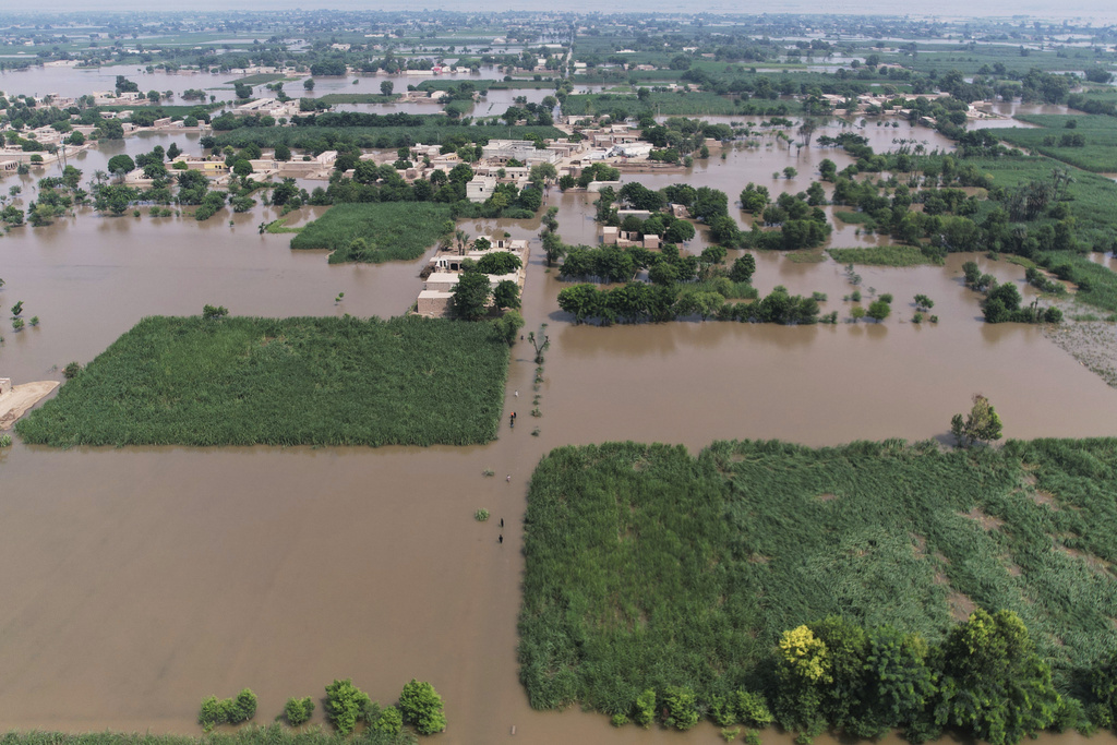Villagers wade through a flooded area, in Tiba Gheal village, in Jhang district, Pakistan, Tuesday, Sept. 2, 2025. (AP Photo/Jahan Zeb)