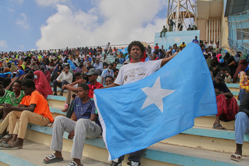 A man holds the flag of Somalia as people gather at the Mogadishu stadium while they protest Israel's recognition of Somalia's breakaway region of Somaliland as an independent nation, in Mogadishu, Somalia, Tuesday, Dec. 30, 2025. (AP photo/Farah Abdi Warsameh)